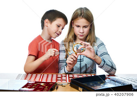 Boy and girl are considering coin collection Boy and girl are considering coin collection 40207906