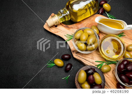 black and green olives and oil on wooden cutting board black and green olives and oil on wooden cutting board 40208190