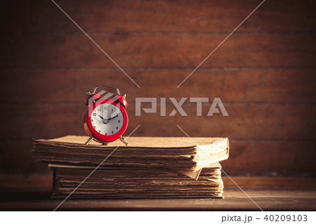 Little alarm clock and books 40209103