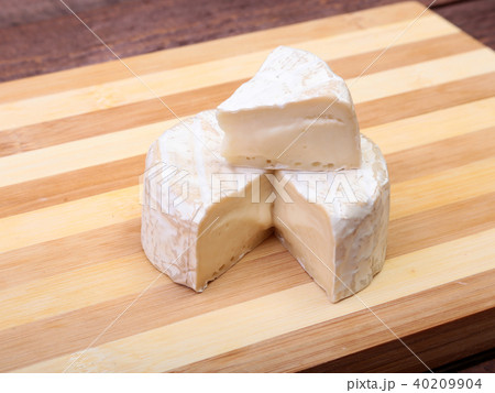 Cheese with white mold. Camembert or brie type on wood table. Healthy breakfast. 40209904