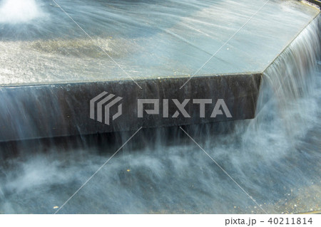 Water flowing in city fountain 40211814