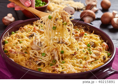 holding a fork with portion of Tetrazzini 40215891