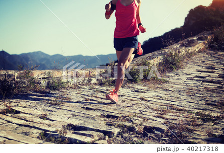 sporty woman trail runner running on mountain top sporty woman trail runner running on mountain top 40217318