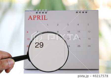 Magnifying glass in hand on calendar you can look Twenty-nine day of month,Focus number Twenty-nine in April. Magnifying glass in hand on calendar you can look Twenty-nine day of month,Focus number Twenty-nine in April. 40217578