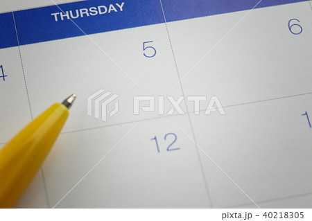 yellow pen points to the number 5 on calendar background. yellow pen points to the number 5 on calendar background. 40218305