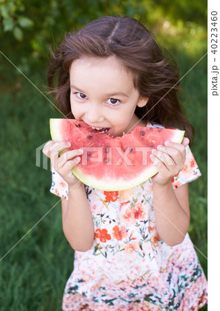 Bright green grass. Little beautiful girl.  40223460