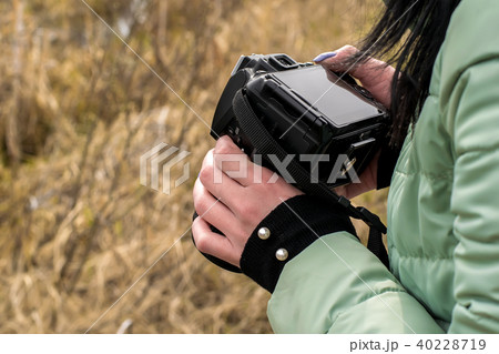grass girl holding a camera 40228719