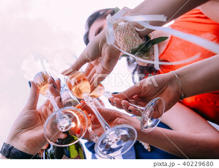 friends drink champagne raise glasses outside sky 40229680
