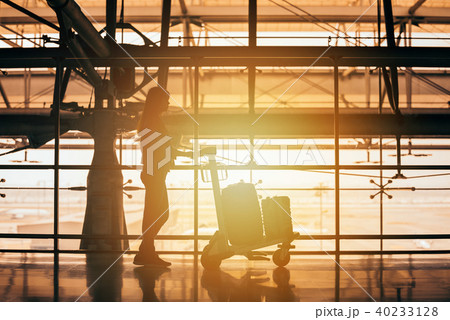 Passenger woman walking through an airport Passenger woman walking through an airport 40233128