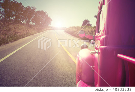 pink retro car on the road 40233232