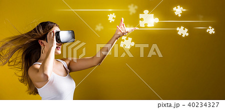 Puzzle Pieces with woman using a virtual reality headset 40234327