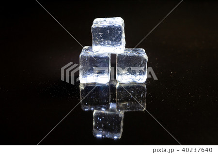 ice cubes reflection on black table background. ice cubes reflection on black table background. 40237640