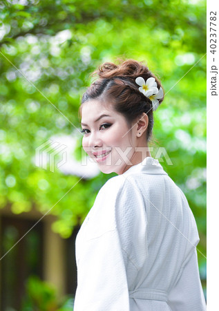 Beautiful girl dress in Bathrobe in the garden 40237782