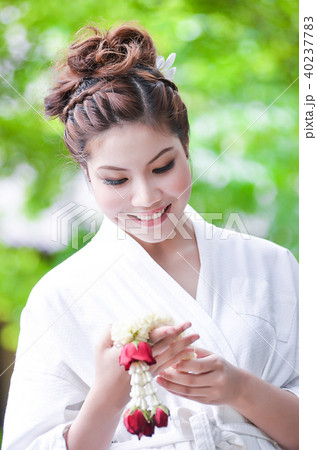 Beautiful girl dress in Bathrobe holding flower Beautiful girl dress in Bathrobe holding flower 40237783