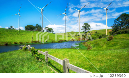 Wind turbines farm on a green grass hills. 40239360