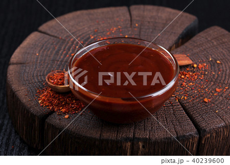 Ketchup in bowl on dark wooden background Ketchup in bowl on dark wooden background 40239600