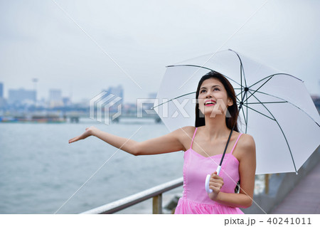 Holiday concept. Beautiful girl is holding umbrella on the beach 40241011