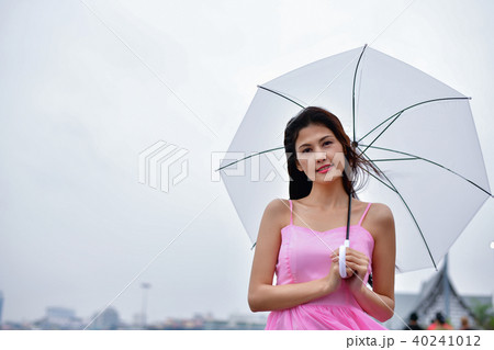 Holiday concept. Beautiful girl is holding umbrella on the beach Holiday concept. Beautiful girl is holding umbrella on the beach 40241012