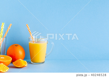 Orange juice on a blue pastel background Orange juice on a blue pastel background 40246528
