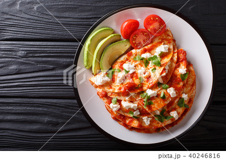 Serving Mexican Entomatadas with cottage cheese 40246816