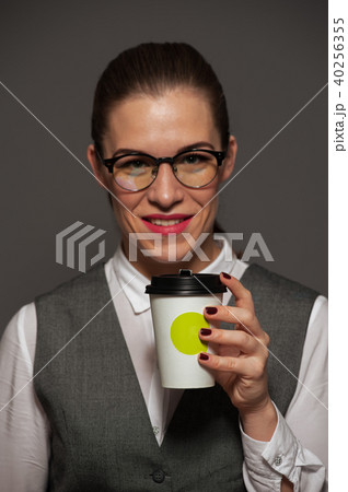 Successful businesswoman posing with coffee mug 40256355