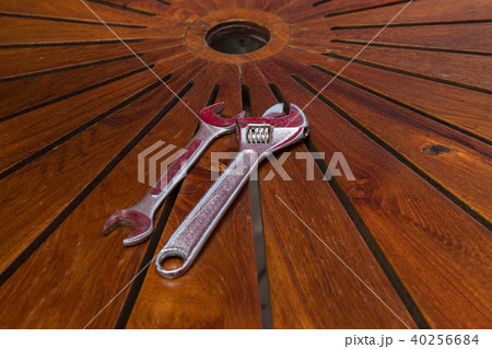 Adjustable wrench on wooden table Adjustable wrench on wooden table 40256684