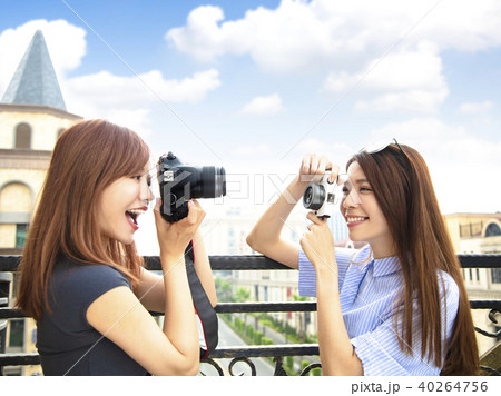 two happy girls holding camera and travel concept 40264756
