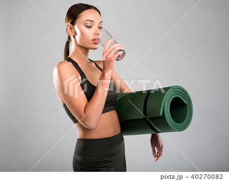 Slim girl quenching thirst after fitness classes 40270082