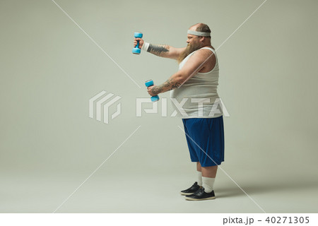 Strained fat man lifting dumbbells Strained fat man lifting dumbbells 40271305