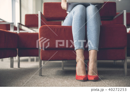 Female feet putting on fashionable footwear Female feet putting on fashionable footwear 40272253