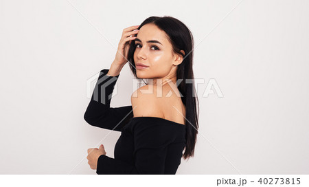 Side view of young model wearing black dress Side view of young model wearing black dress 40273815