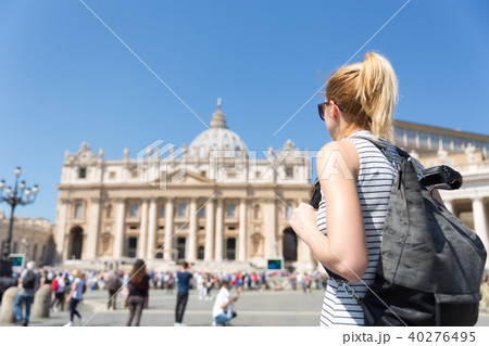 Woman on St. Peter's Square in Vatican in front of St. Peter's Basilica. 40276495