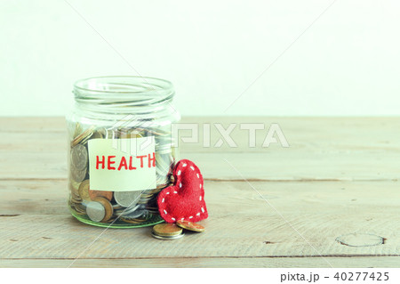Coins in jar with Health label 40277425