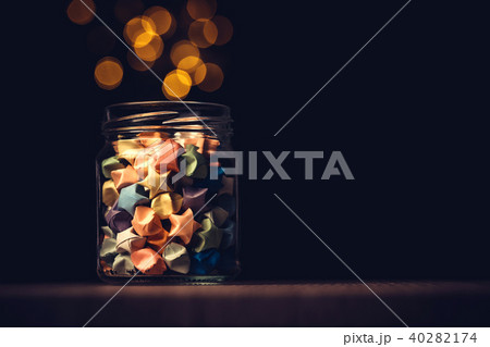 Star origami in glass jar with a festival light 40282174