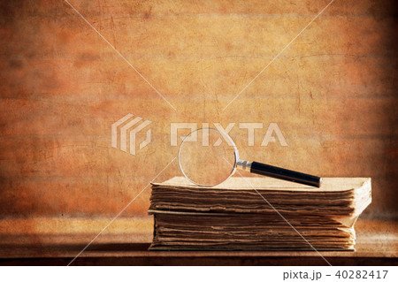 little magnifier and book on a table little magnifier and book on a table 40282417