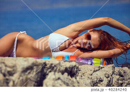 slim attractive woman posing in blue waters of Adriatic sea beac 40284240