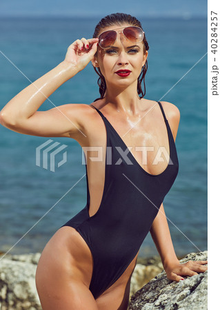 slim attractive woman posing in blue waters of Adriatic sea beac 40284257