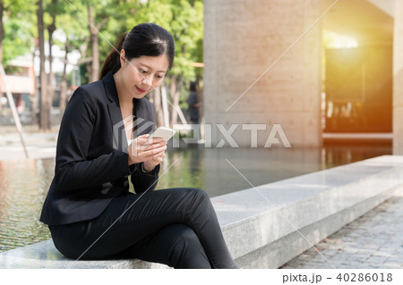 professional young Asian texting message professional young Asian texting message 40286018