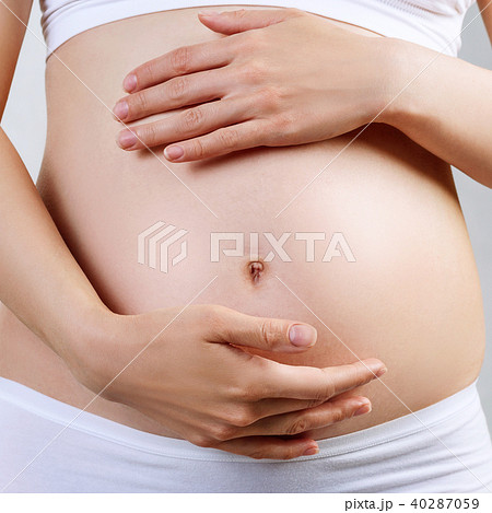 Young pregnant woman caress belly. 40287059