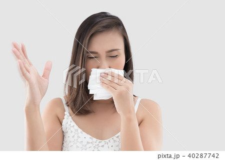 Asian woman in white dress catch her nose because of a bad smell 40287742
