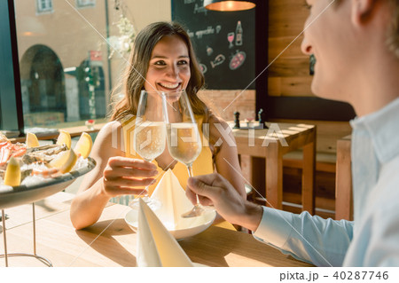 Beautiful woman toasting during a romantic dinner with her partner Beautiful woman toasting during a romantic dinner with her partner 40287746