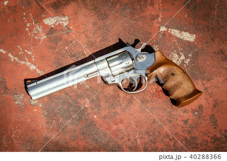 handgun on the concrete red backgroound 40288366