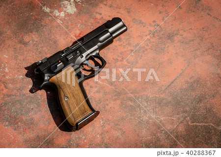handgun on the concrete red backgroound 40288367