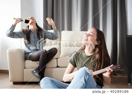 Two sisters having fun in the living room 40289186