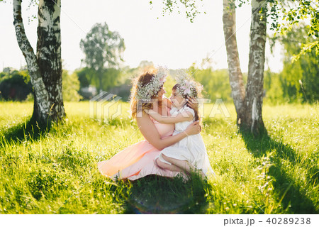 happy beautiful mother with a daughter of Caucasian appearance hugging in the meadow 40289238