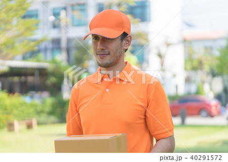 Delivery man in orange is handing packages Delivery man in orange is handing packages 40291572