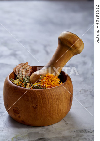 Spa still life with flowers in wooden bowl on light textured background, top view, close-up Spa still life with flowers in wooden bowl on light textured background, top view, close-up 40291612