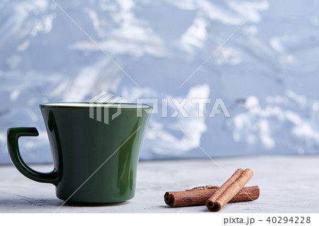 Cup of creamy coffee with cinnamon and star anise on a white textured background, top view, close-up 40294228