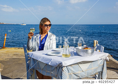 Young woman in a restaurant by the sea 40295427