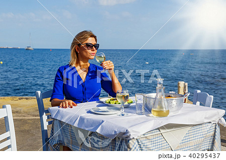 Young woman in a restaurant by the sea 40295437